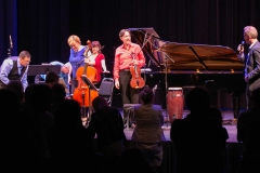 ENSEMBLE VIVANT: Jim Vivian, bass, Corey Gemmell, violin; Catherine Wilson, piano; Sybil Shanahan, cello; Norman Hathaway, violin.  Fredrik Alatalo, Chief Administrative Officer, telMAX with mic; standing ovations for Ensemble Vivant.  Photo by Marion Voysey