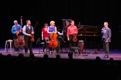 Ensemble Vivant L to R: Jim Vivian, bass, Corey Gemmell, violin; Catherine Wilson, piano; Sybil Shanahan, cello; Norman Hathaway, violin.  Fredrik Alatalo, Chief Administrative Officer, telMAX with mic; standing ovations for Ensemble Vivant.  Photo by Marion Voysey